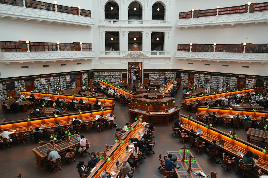 Classic reading room with wooden tables and lamps